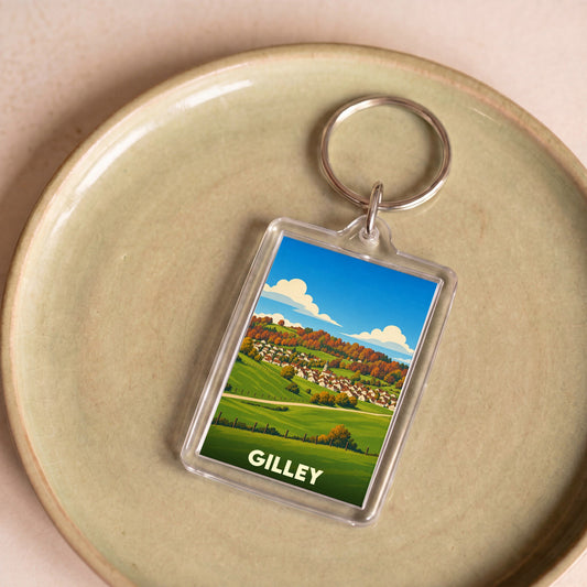 Porte-clés souvenir de la ville de Gilley avec une illustration stylisée d'un paysage rural.
