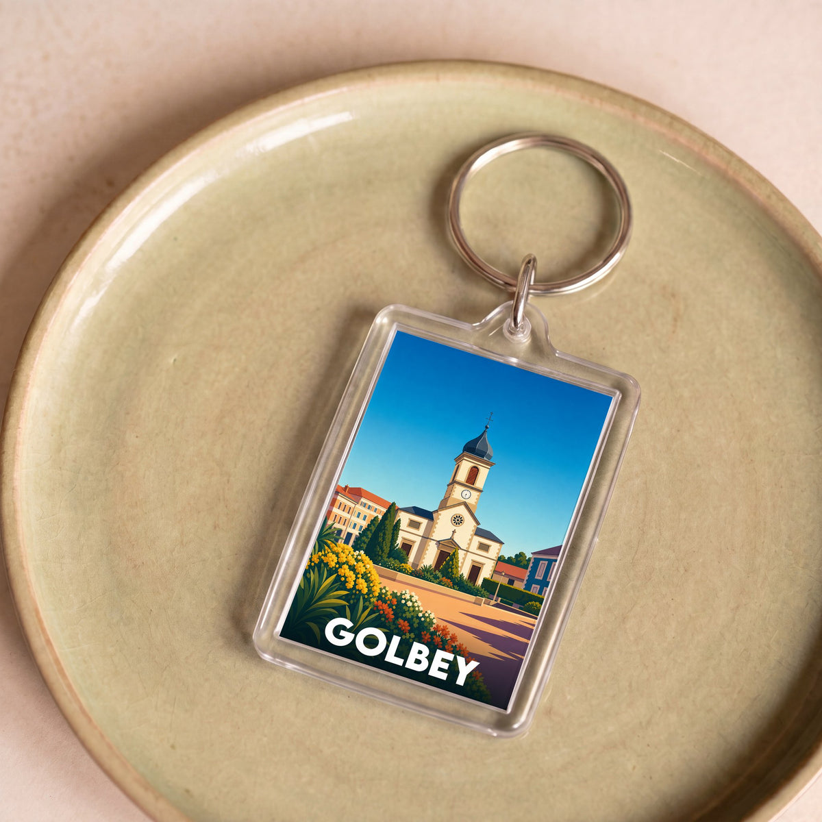 Porte-clés souvenir de la ville de Golbey avec une illustration stylisée.