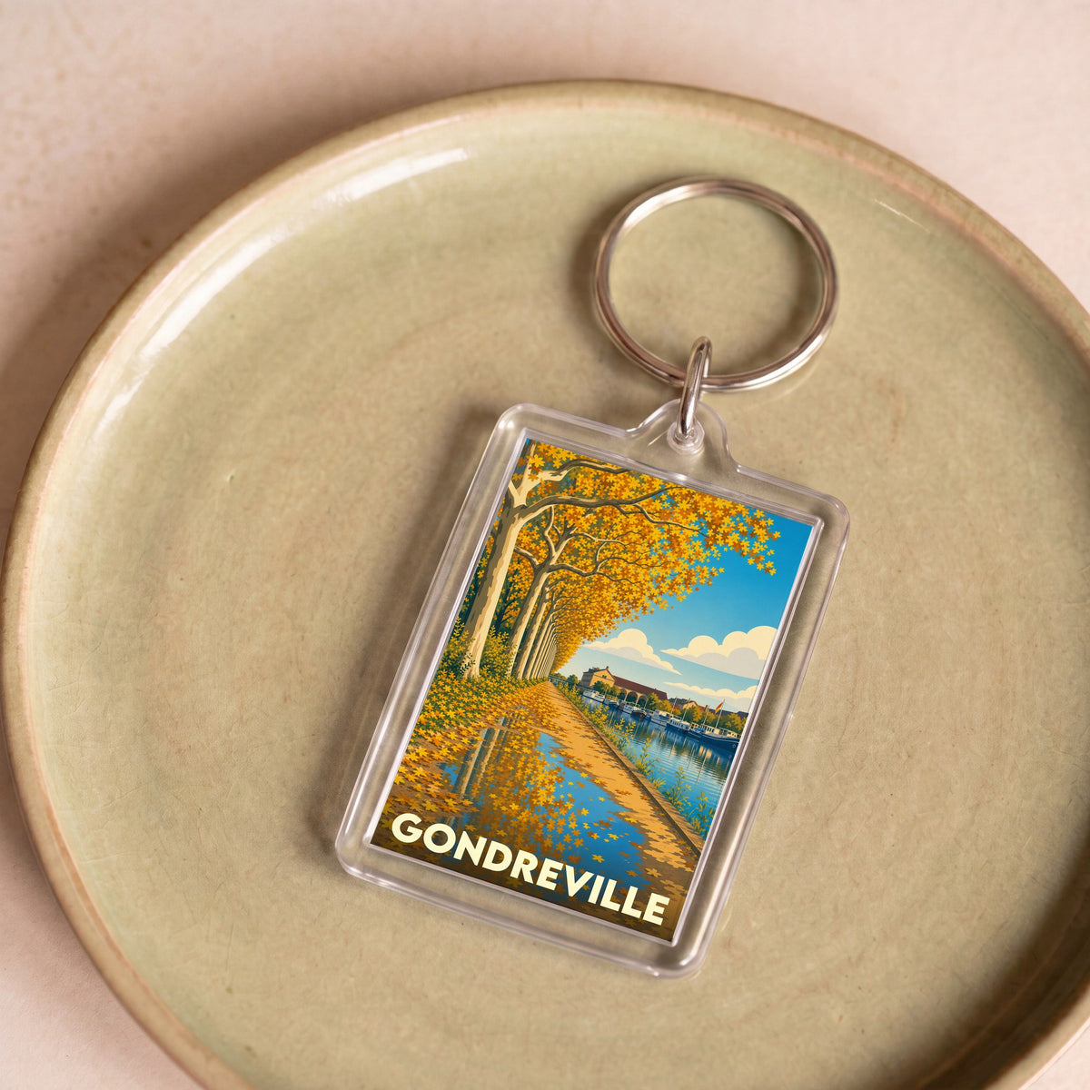 Porte-clés souvenir de la ville de Gondreville avec une illustration automnale stylisée.