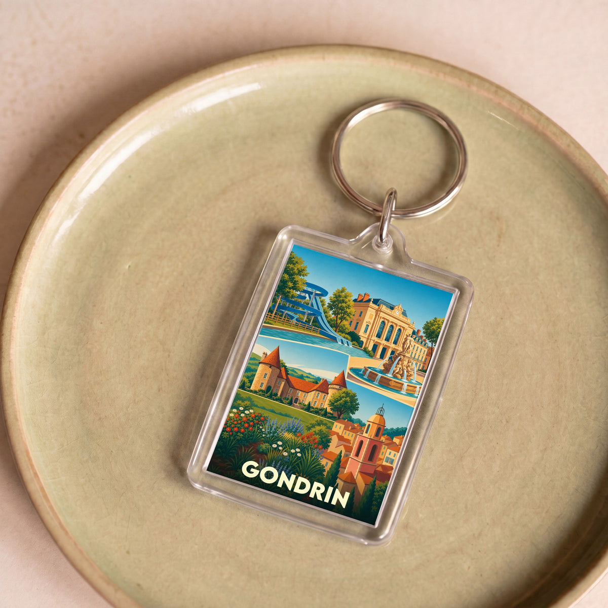 Porte-clés souvenir de la ville de Gondrin avec une illustration stylisée de ses monuments.