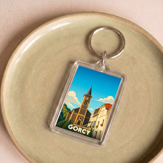 Porte-clés souvenir de la ville de Gorcy avec une illustration stylisée.