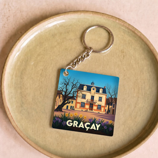 Porte-clés souvenir de la ville de Graçay avec une illustration stylisée.