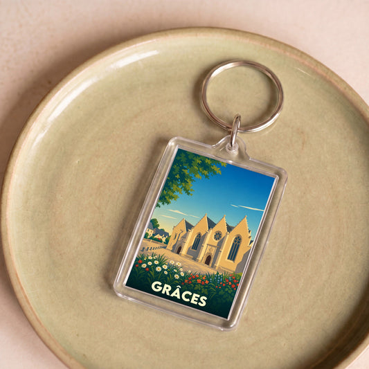 Porte-clés souvenir de la ville de Grâces avec une illustration stylisée de son église.