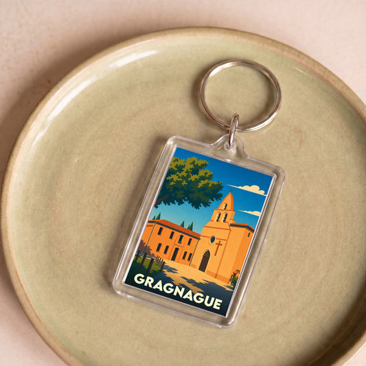 Porte-clés souvenir de la ville de Gragnague avec une illustration stylisée de son église.