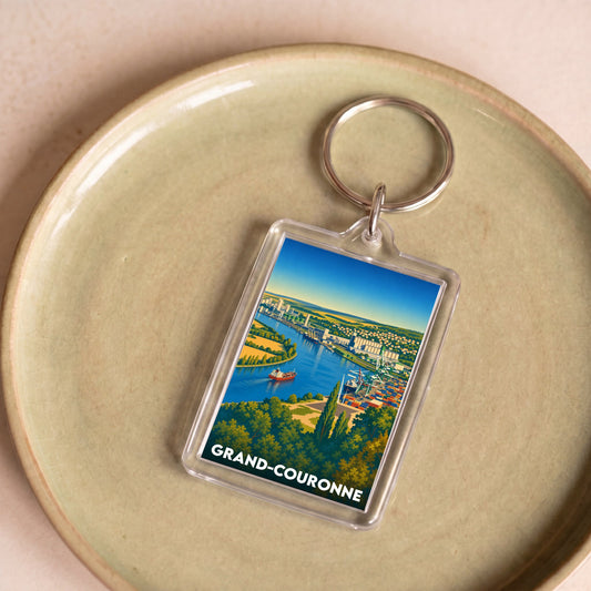 Porte-clés souvenir de la ville de Grand-Couronne avec une illustration stylisée.