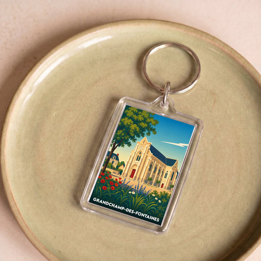 Porte-clés souvenir de la ville de Grandchamp-des-Fontaines avec une illustration stylisée de son église.