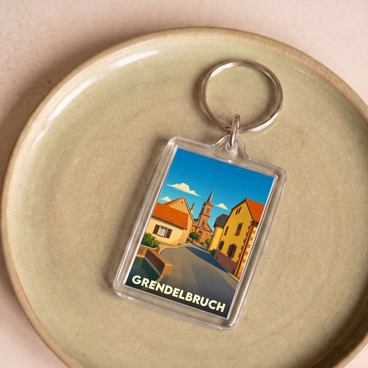 Porte-clés souvenir de la ville de Grendelbruch avec une illustration stylisée.