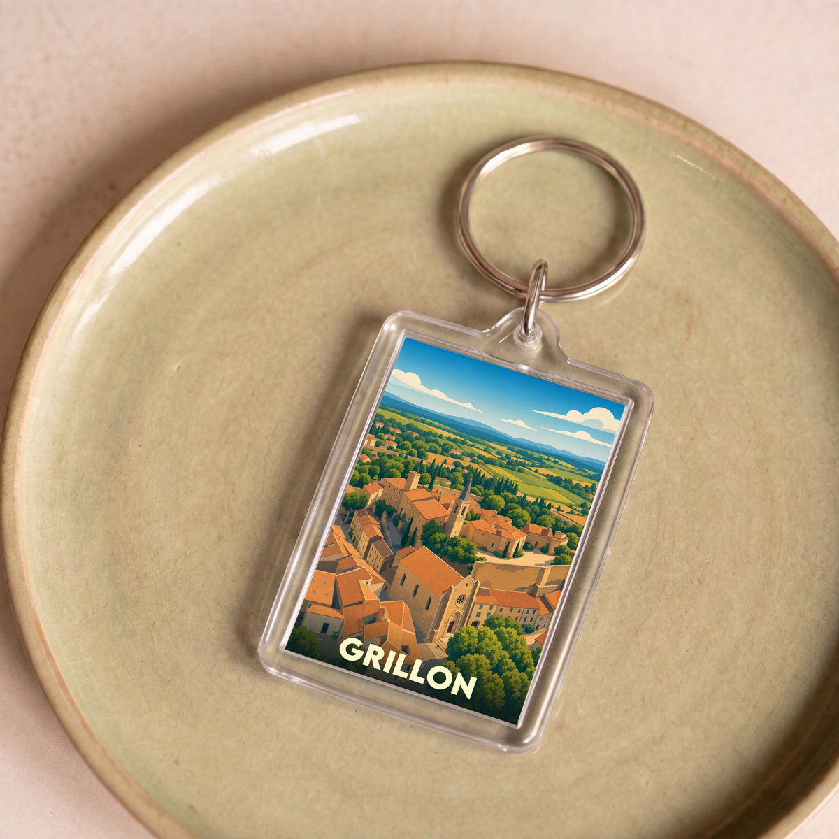 Porte-clés souvenir de la ville de Grillon avec une illustration stylisée.