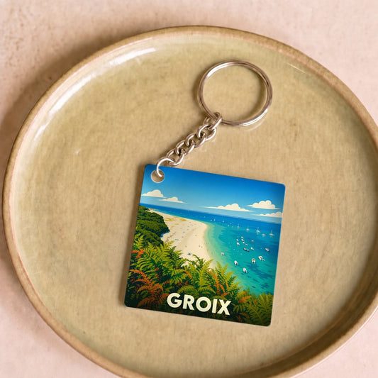 Porte-clés souvenir de l'île de Groix avec une illustration stylisée de plage et de nature.