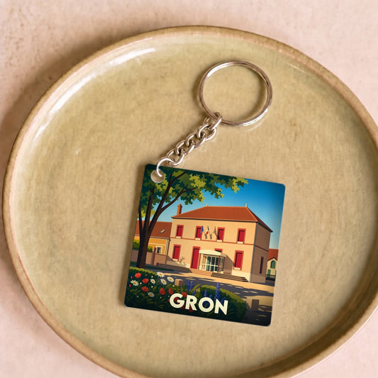 Porte-clés souvenir de la ville de Gron avec une illustration stylisée.