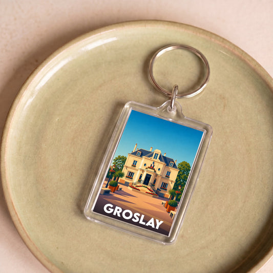 Porte-clés souvenir de la ville de Groslay avec une illustration stylisée d'une bâtisse historique.