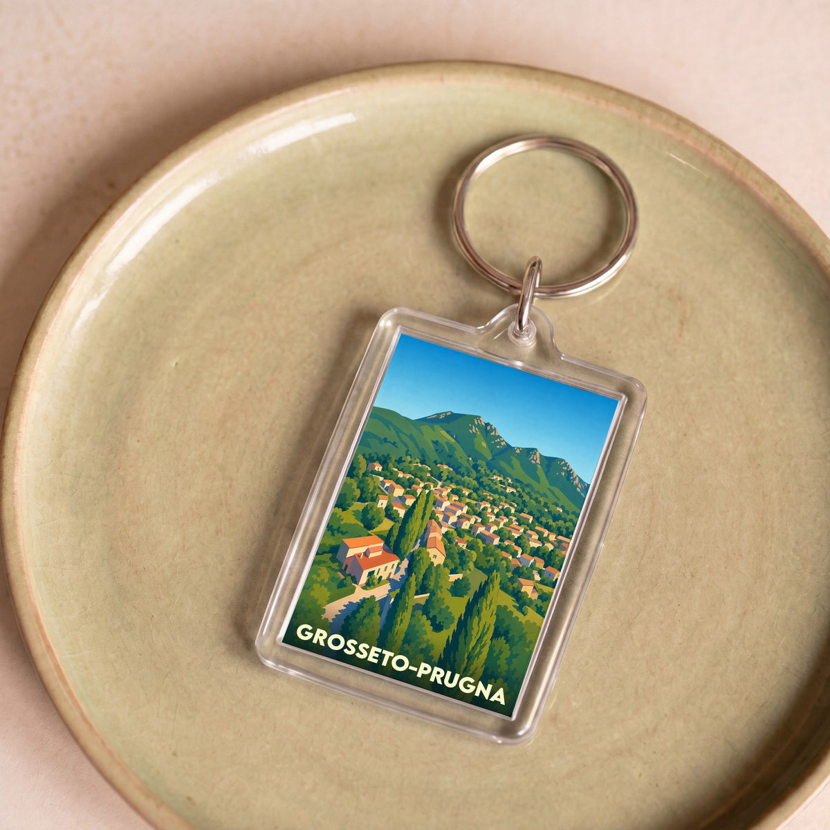 Porte-clés souvenir de la ville de Grosseto-Prugna avec une illustration stylisée.