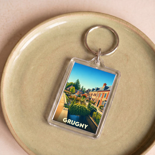 Porte-clés souvenir de la ville de Grugny avec une illustration stylisée.