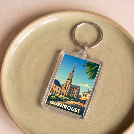 Porte-clés souvenir de la ville de Guenrouet avec une illustration stylisée de son église.