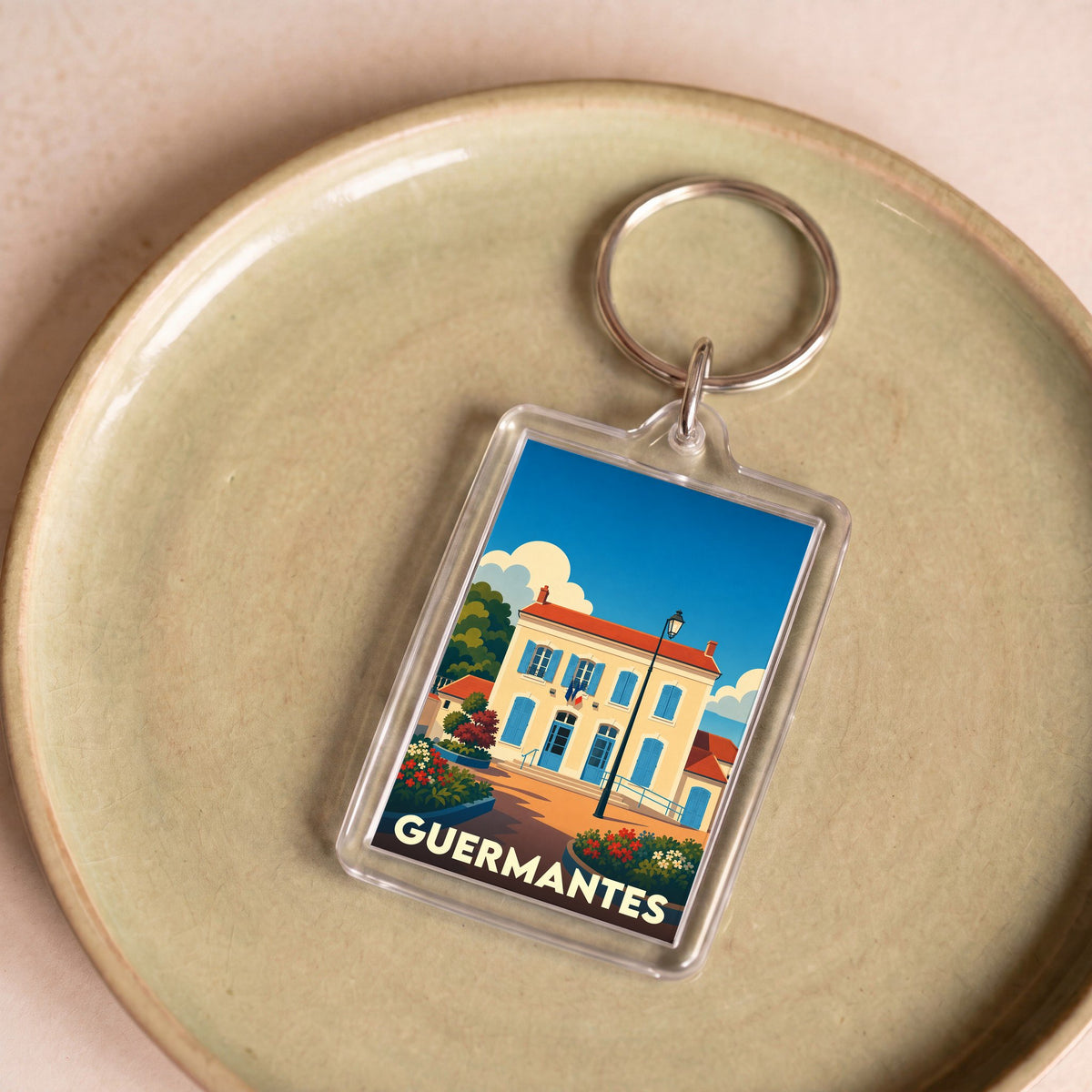 Porte-clés souvenir de la ville de Guermantes avec une illustration stylisée.
