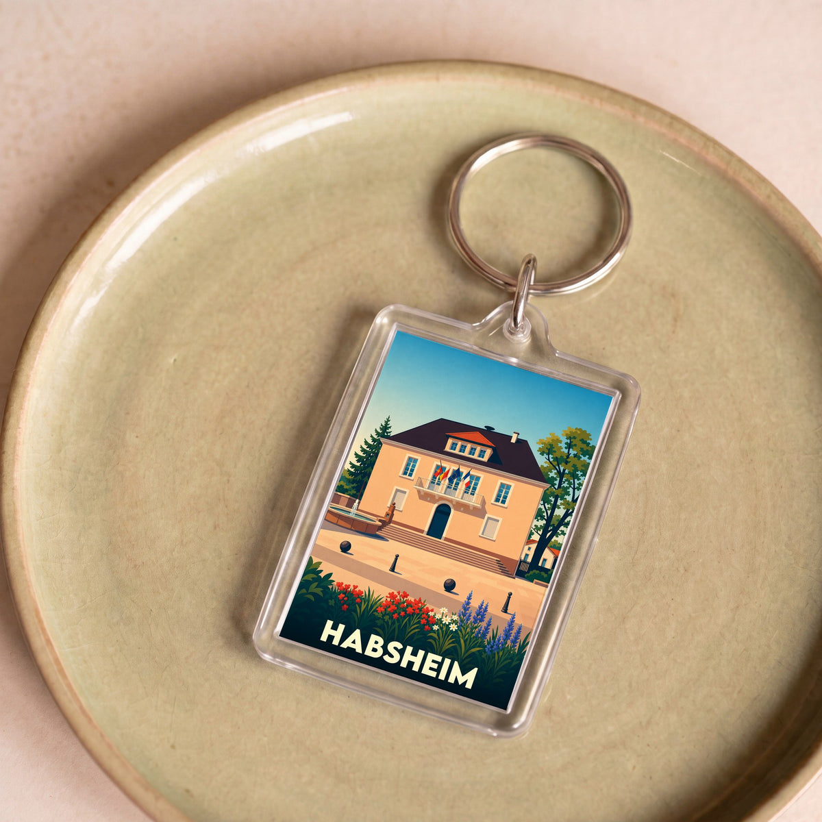 Porte-clés souvenir de la ville de Habsheim avec une illustration stylisée de son hôtel de ville.