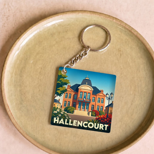 Porte-clés souvenir de la ville de Hallencourt avec une illustration stylisée de l'hôtel de ville.