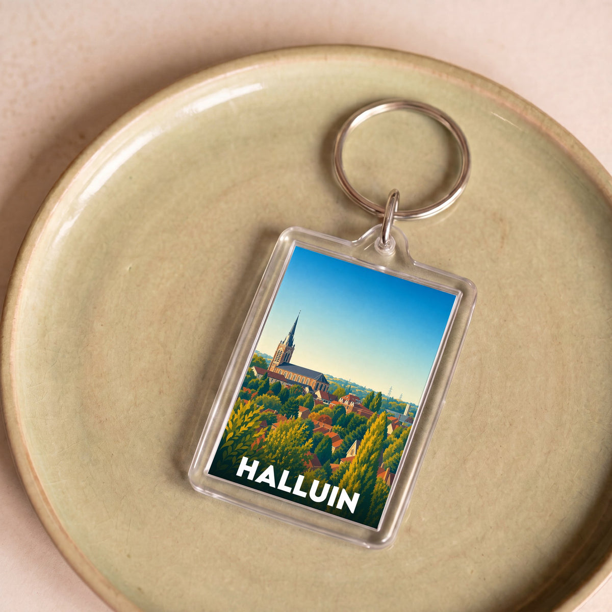 Porte-clés souvenir de la ville de Halluin avec une illustration stylisée.