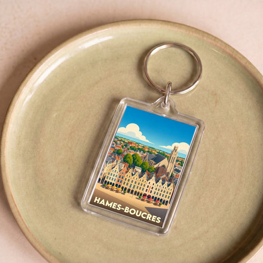 Porte-clés souvenir de la ville de Hames-Boucres avec une illustration stylisée.
