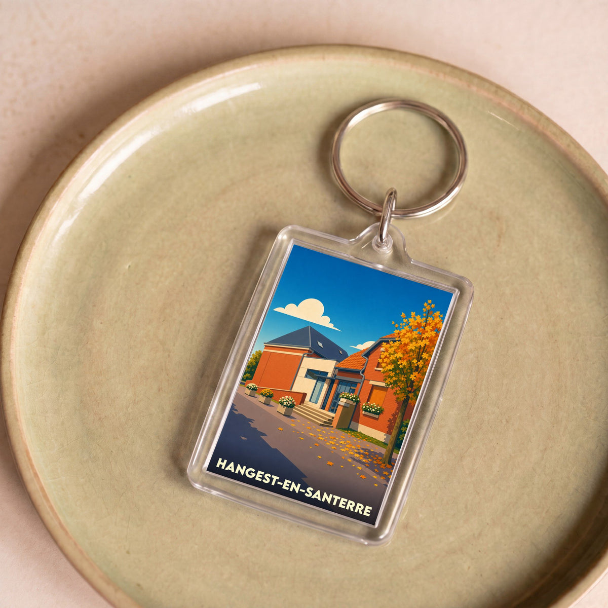 Porte-clés souvenir de la ville de Hangest-en-Santerre avec une illustration stylisée.