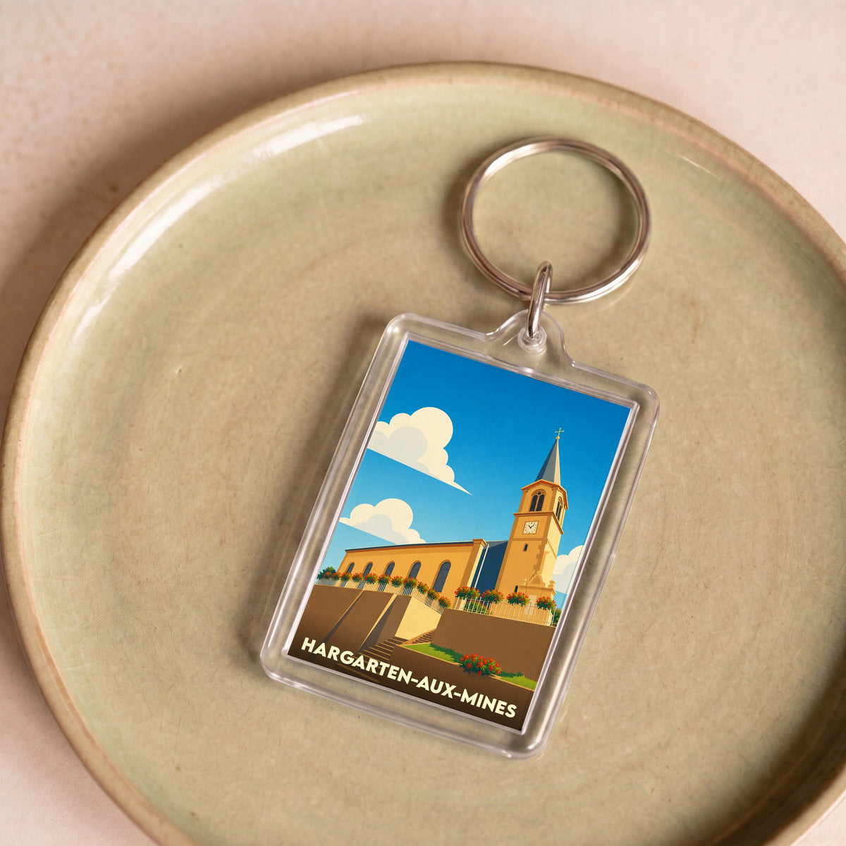 Porte-clés souvenir de la ville de Hargarten-aux-Mines avec une illustration stylisée de son église.