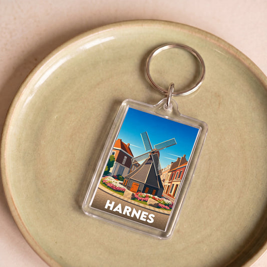 Porte-clés souvenir de la ville de Harnes avec une illustration stylisée.