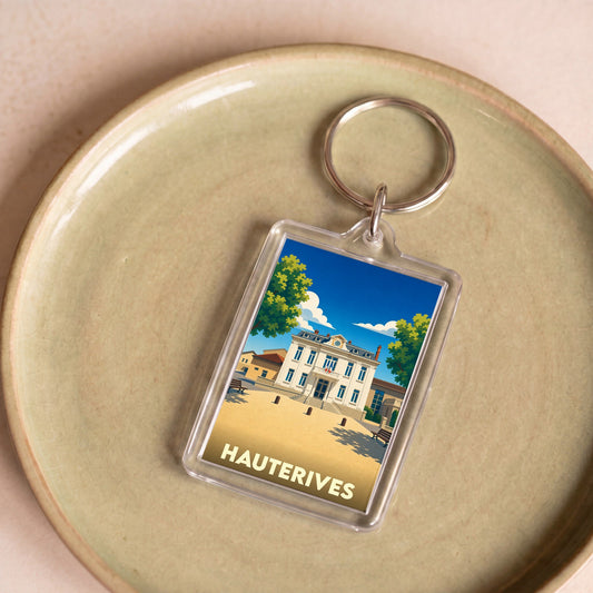 Porte-clés souvenir de la ville de Hauterives avec une illustration stylisée de la mairie.