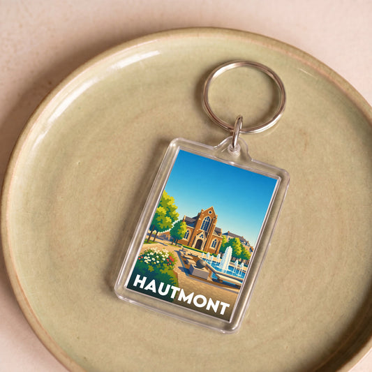 Porte-clés souvenir de la ville de Hautmont avec une illustration stylisée.