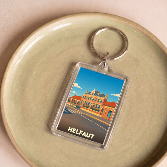 Porte-clés souvenir de la ville de Helfaut avec une illustration stylisée.