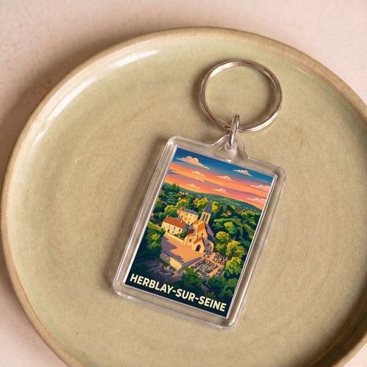 Porte-clés souvenir de la ville de Herblay-sur-Seine avec une illustration stylisée de son paysage.