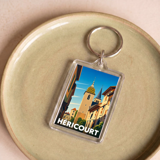 Porte-clés souvenir de la ville de Héricourt avec une illustration stylisée.