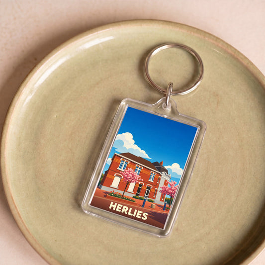 Porte-clés souvenir de la ville de Herlies avec une illustration stylisée de sa mairie.