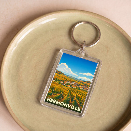Porte-clés souvenir de la ville de Hermonville avec une illustration stylisée de vignobles.