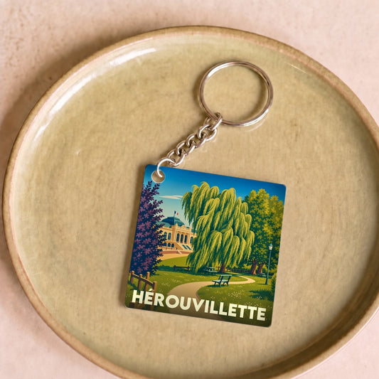 Porte-clés souvenir de la ville de Hérouvillette avec une illustration stylisée d'un parc.
