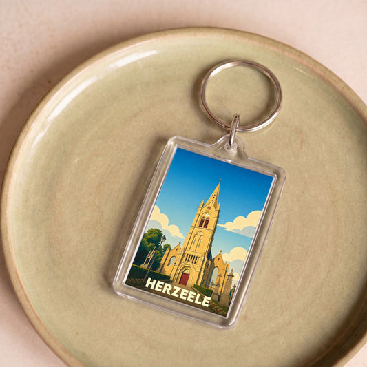 Porte-clés souvenir de la ville de Herzeele avec une illustration stylisée de son église.