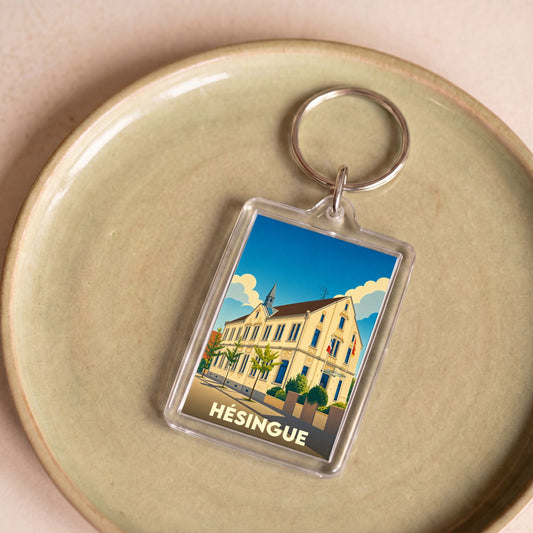 Porte-clés souvenir de la ville de Hésingue avec une illustration stylisée.