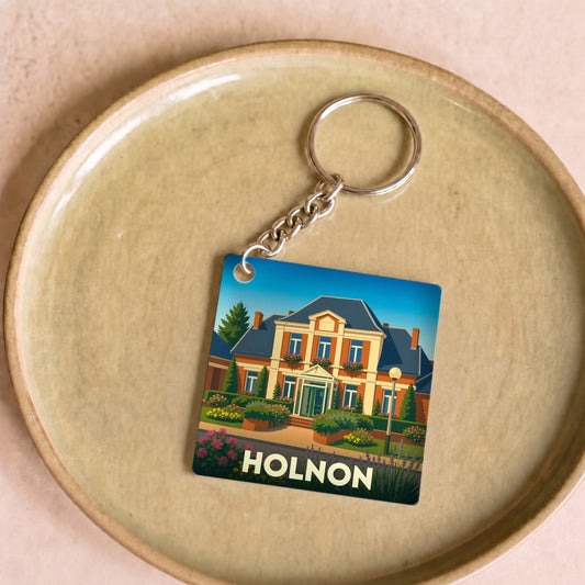 Porte-clés souvenir de la ville de Holnon avec une illustration stylisée d'une demeure bourgeoise.