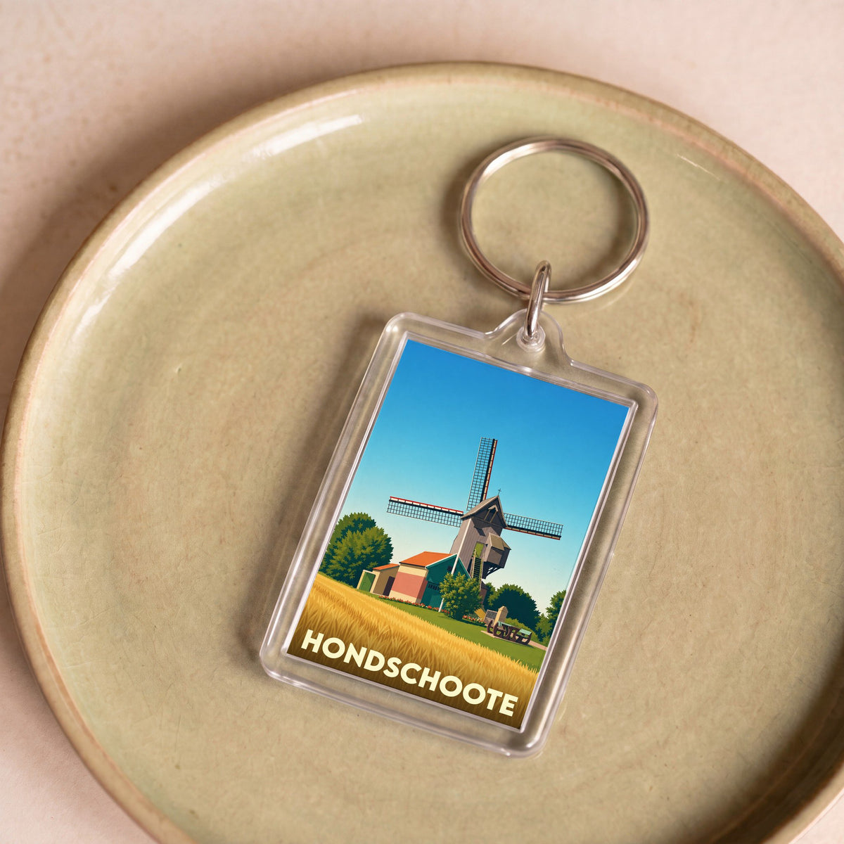 Porte-clés souvenir de la ville de Hondschoote avec une illustration stylisée d'un moulin.