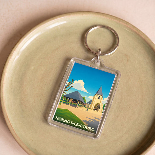 Porte-clés souvenir de la ville de Hornoy-le-Bourg avec une illustration stylisée.