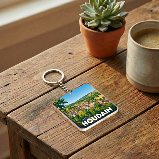 Porte-clés souvenir de la ville de Houdain avec une illustration stylisée de son paysage.