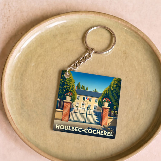 Porte-clés souvenir de la ville de Houlbec-Cocherel avec une illustration stylisée.
