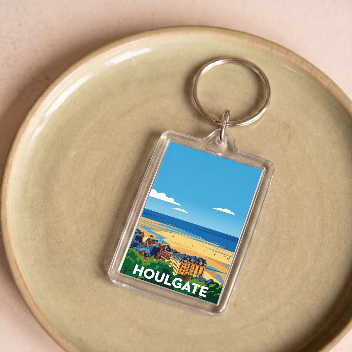 Porte-clés souvenir de la ville de Houlgate avec une illustration stylisée.