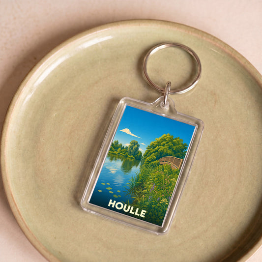 Porte-clés souvenir de la ville de Houlle avec une illustration stylisée représentant un paysage de rivière.