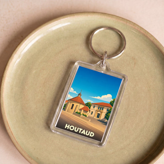 Porte-clés souvenir de la ville de Houtaud avec une illustration stylisée.