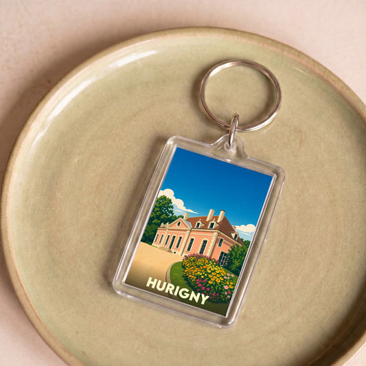 Porte-clés souvenir de la ville de Hurigny avec une illustration stylisée d'un château.