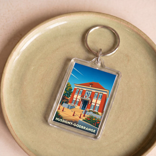 Porte-clés souvenir de la ville de Hussigny-Godbrange avec une illustration stylisée de sa mairie.