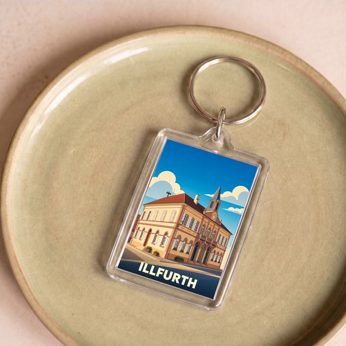 Porte-clés souvenir de la ville d'Illfurth avec une illustration stylisée de son hôtel de ville.