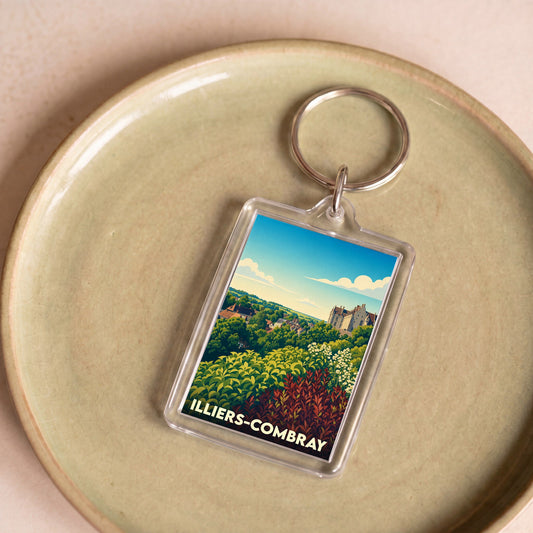 Porte-clés souvenir de la ville de Illiers-Combray avec une illustration paysagère stylisée.