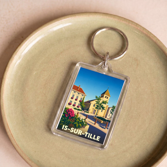 Porte-clés souvenir de la ville de Is-sur-Tille avec une illustration stylisée.