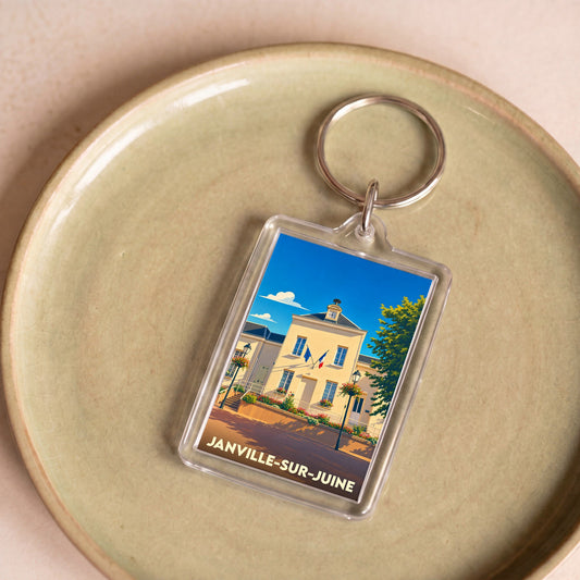 Porte-clés souvenir de la ville de Janville-sur-Juine avec une illustration stylisée de sa mairie.